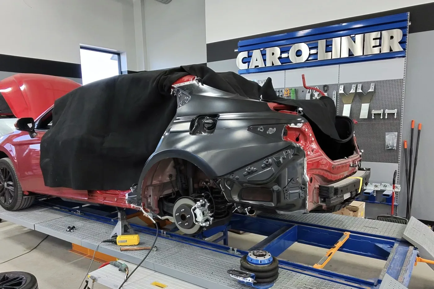 A vehicle on the frame bench at the Luxury Auto Body Round Rock shop